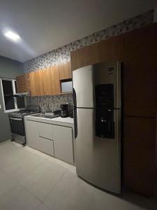 a kitchen with a refrigerator and a stove at Kobikhome in Cancún