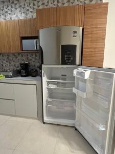 a refrigerator with its door open in a kitchen at Kobikhome in Cancún
