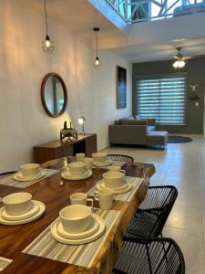 a living room with a wooden table with dishes on it at Kobikhome in Cancún