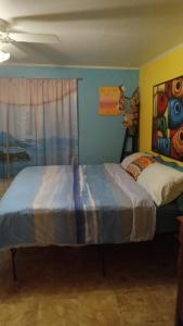 a bedroom with a bed and a painting on the wall at cozy 1drm beach place Treasure Island in St. Pete Beach