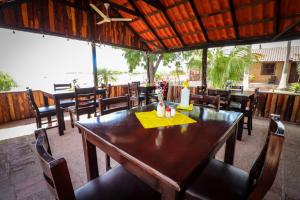 a restaurant with a wooden table and chairs with a candle at Hotel Villa Dominguez 