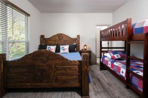 a bedroom with two beds and a bunk bed at Southern Comfort RR 7252 in Canyon Lake
