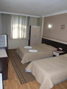 מיטה או מיטות בחדר ב-Kosar Hotel