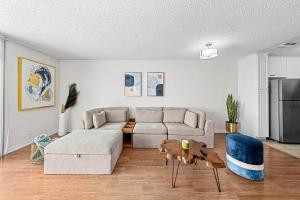 a living room with a couch and a table at Sun-Kissed Oceanfront Gem with Spectacular Views in Los Angeles