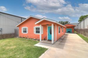 a small orange house with a blue door in a yard at Jewel's Peace of Paradise in Rockport