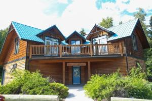 a large wooden house with a large deck at Eagle Cabin in Golden