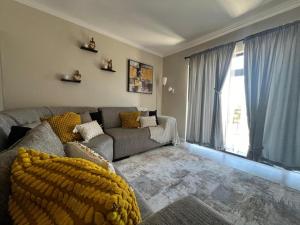 a living room with a couch and a large window at The Palms Unit 5 in Kimberley