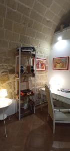 a room with a desk and a table and a table and chair at Palazzo Saraceno apartments-Antico Rifugio in Taranto