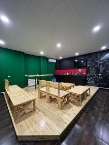 a ping pong table and benches in a room at Salut Hotel in Bishkek