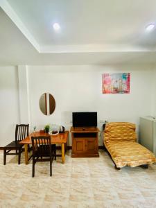 a living room with a bed and a table at BT hotel Kata Beach in Kata Beach