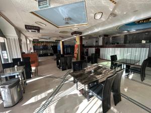 a restaurant with tables and chairs and a tv on the ceiling at Safari Hotel in Nizwa +20 photos