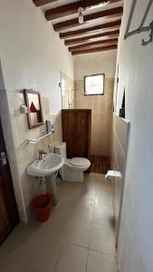 a bathroom with a toilet and a sink at Light of Zanzibar Hotel in Nungwi