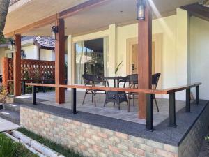 a patio with a table and chairs on it at Tohsang Heritage Khongjiam in Khong Chiam