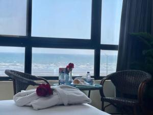 a table in a room with a view of the ocean at فندق ماريوت عدن السياحي Marriott Aden Hotel in Khawr Maksar