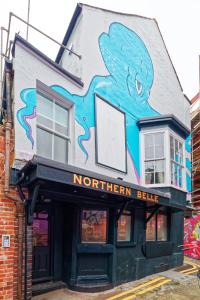a building with a painting on the side of it at Northern Belle four Bedroom Apartment in Margate