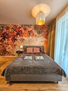 een slaapkamer met een bed met een bloemenmuur bij STARE MIASTO KWIATY in Elblag