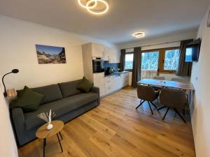 a living room with a couch and a table at Haus Tennstein in Schladming