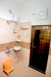 a bathroom with a sink and a toilet and a mirror at Bhagora CJMA Home Stay/Villa in Udaipur
