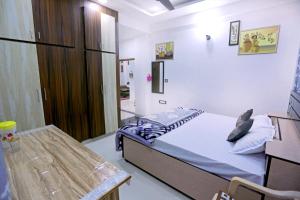 a small bedroom with a bed and a table at Bhagora CJMA Home Stay/Villa in Udaipur