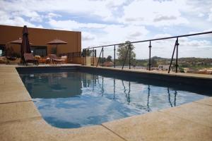 a swimming pool in front of a building at Nosy Manga - Hotel Ivato Airport in Antananarivo