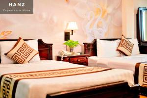 HANZ Thanh Thu Hotel tesisinde bir odada yatak veya yataklar