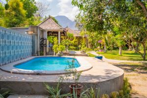 a swimming pool in the backyard of a house at Biorock Homestay & Dive Center Pemuteran in Pemuteran