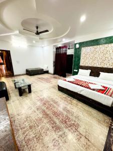 a large room with a bed and a couch at Abu Safari Jaisalmer in Jaisalmer