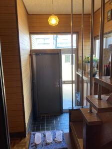 a hallway with a black door in a room at Classy仏生山 in Takamatsu +46 photos