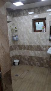 a bathroom with a shower with a toilet in it at Gabala House in Gabala