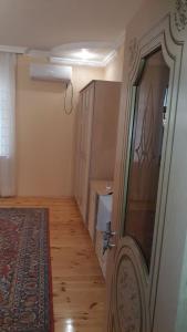 a room with a hallway with a door and a rug at Gabala House in Gabala