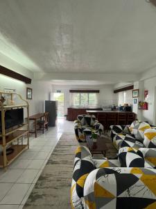 a living room with couches and a table and a kitchen at Island Accommodation Suva Premier Hospitality in Suva