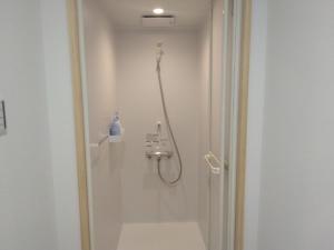 a bathroom with a shower and a toilet at お宿イレブン 