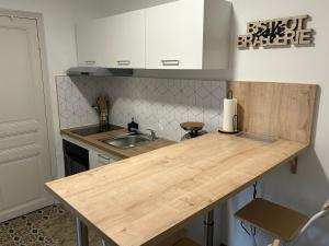 a kitchen with a wooden counter top and a sink at notre dame des anges in Lurs