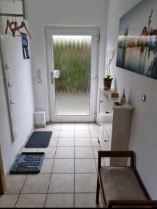 a room with a door and a tile floor at Fewo Neuruppin Einliegerwohnung in Neuruppin