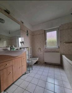 a bathroom with a tub and a sink and a bath tub at Fewo Neuruppin Einliegerwohnung in Neuruppin