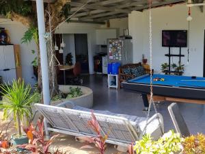 a patio with a hammock and a pool table at Hilltop Haven 