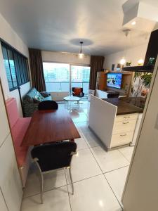 a kitchen and living room with a wooden table and chairs at Liège centre 13 Quai Godefroid Kurth POUR 2 PERS à 25 min gare Guillemins in Liège