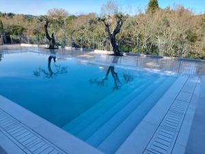 a person in the water in a swimming pool at Luxury Villa Breeze with Private Pools in Dassia