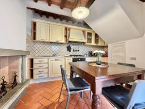 a kitchen with a wooden table and chairs at FRONTE MURA LUCCA - Parcheggio - WiFi Il CORTIGIANO in Lucca