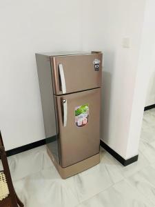 a refrigerator sitting in the corner of a room at Manorama Palace in Mirissa