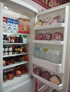 an open refrigerator filled with lots of food at La Casa de La Abuela Rosy in Málaga