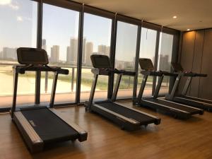 a row of treadmills in a gym with a large window at Penang Amazing SeaView Private Lift 梹城富人区绝美海景公寓私人电梯 in Tanjong Tokong