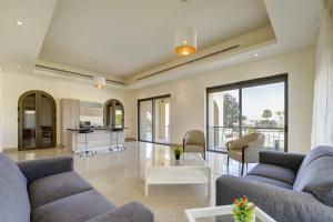 a living room with two couches and a table at Shoreline Apartment - Tala Bay in Aqaba