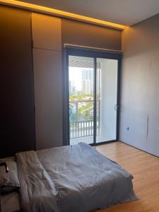 a bedroom with a bed and a large window at Penang Amazing SeaView Private Lift 梹城富人区绝美海景公寓私人电梯 in Tanjong Tokong +25 photos
