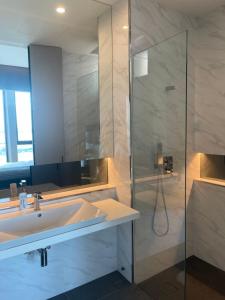 a bathroom with a sink and a shower at Penang Amazing SeaView Private Lift 梹城富人区绝美海景公寓私人电梯 in Tanjong Tokong