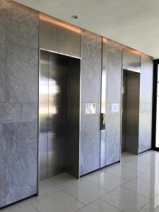 a row of elevator doors in a building at Penang Amazing SeaView Private Lift 梹城富人区绝美海景公寓私人电梯 in Tanjong Tokong