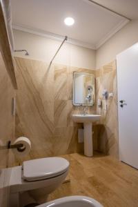 La salle de bains est pourvue de toilettes et d'un lavabo. dans l'établissement Vila Missy, à Deva