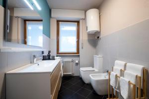 a bathroom with a sink and a toilet at 203 Aosta Apartment in Aosta +12 photos