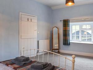 a bedroom with a bed and a mirror at Lower Farm in Llanfihangel Rhydithon