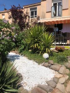 a garden with rocks and plants in front of a building at La Maison du Bonheur in Octon